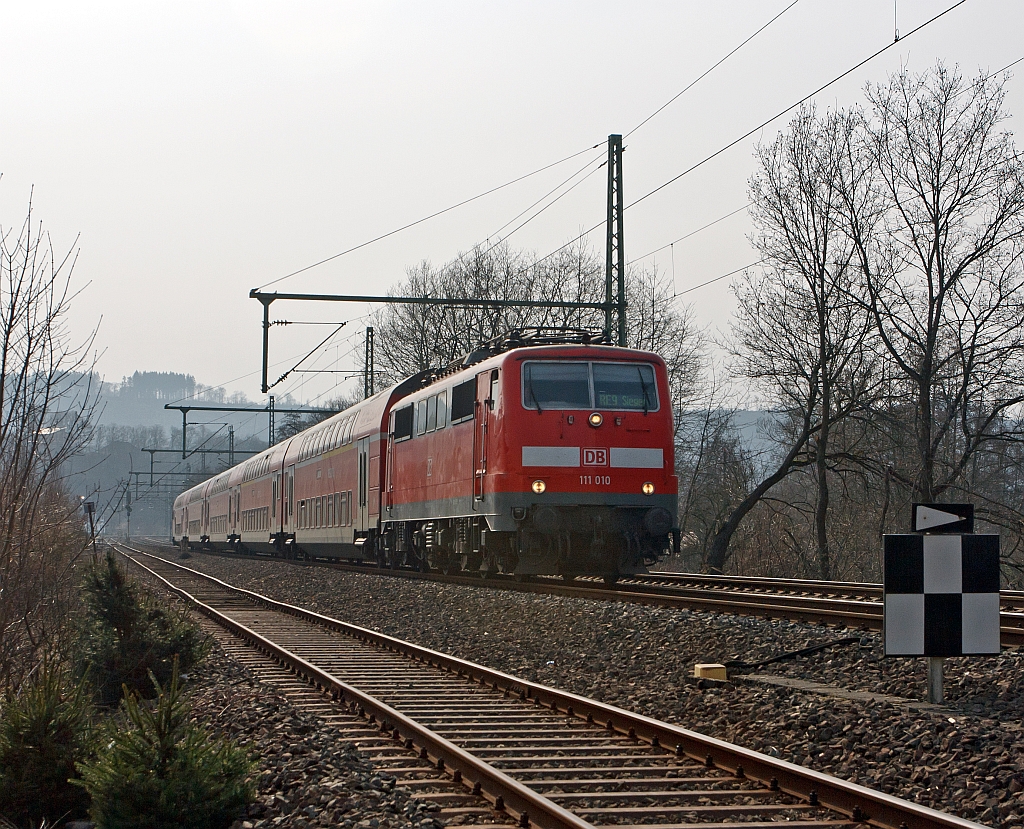 Im Gegenlicht: 111 010 mit dem RE 9 (Rhein-Sieg-Express) Aachen - Kln - Siegen, hier am 17.03.2012 bei Betzdorf-Bruche.