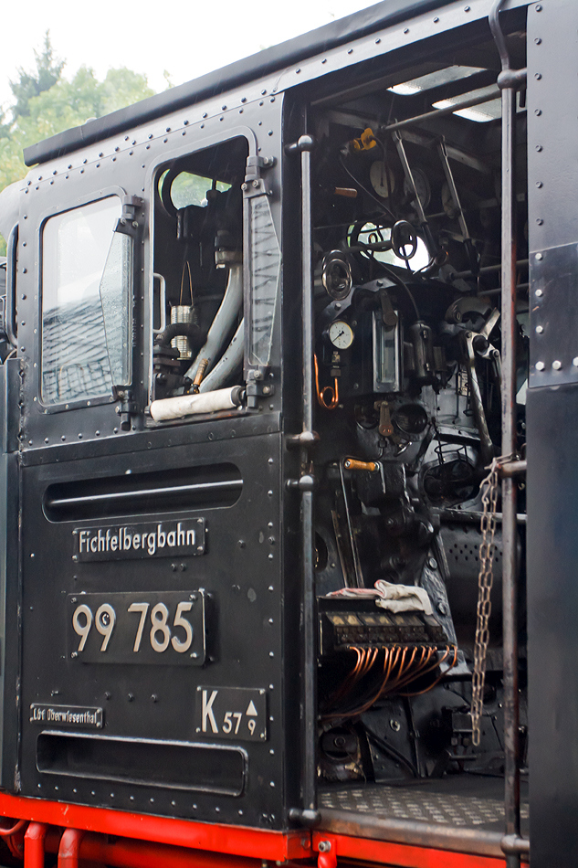 
Detail bzw. Blick in den Fhrerstand von der 99 785 der Fichtelbergbahn (ex DB 099 749-4, ex DR 99 1785-7) am 25.08.2013  in Oberwiesenthal. 

Diese Lok der Baureihe 99.77-79 (schsische VII K Neubau) wurde 1953 bei VEB Lokomotivbau Karl Marx, Babelsberg (vormals O&K) unter der Fabriknummer 32026 gebaut, 1992 erfolgte eine Rekonstruktion im Raw Meiningen (mit Kessel-Nr. 1476 und Rahmen-Nr. 12).  Neben der Baureihe 99.73-76 (schsische VII K Altbau) gehren diese Lokomotiven mit 600 PS (441 KW)Leistung zu den Leistungsstrksten Loks der Spurweite 750 mm.