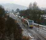 Hellertalbahn Nachschu�: Stadler GTW 2/6 der Hellertalbahn kommt am 09.02.2012, bei ganz leichtem Schneefall, von Neunkirchen und f�hrt gleich in den Bahnhof Herdorf ein. Danach f�hrt er weiter in Richtung Betzdorf/Sieg, hier besteht dann Anschlu� an den RE 9 (Rhein-Sieg-Express). Links das Stellwerk Herdorf Ost (Ho). ganz hinten links das Stellwerk Herdorf Fahrdienstleiter (Hf). Hinten rechts der Gleise der Bahnhof, davor der ehem. G�terbahnhof.