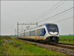 Zwei gekuppelte vierteilige NS SLT (Sprinter Lighttrain) werden in Krze den Bahnhof von Zevenbergen erreichen und danach ihre Fahrt nach Roosendaal fortsetzen.
