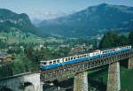 MOB: Stilreiner Regionalzug mit dem ABDe 8/8 4002  VAUD  beim Passieren des Viaduktes bei Gstaad im Juli 1991.