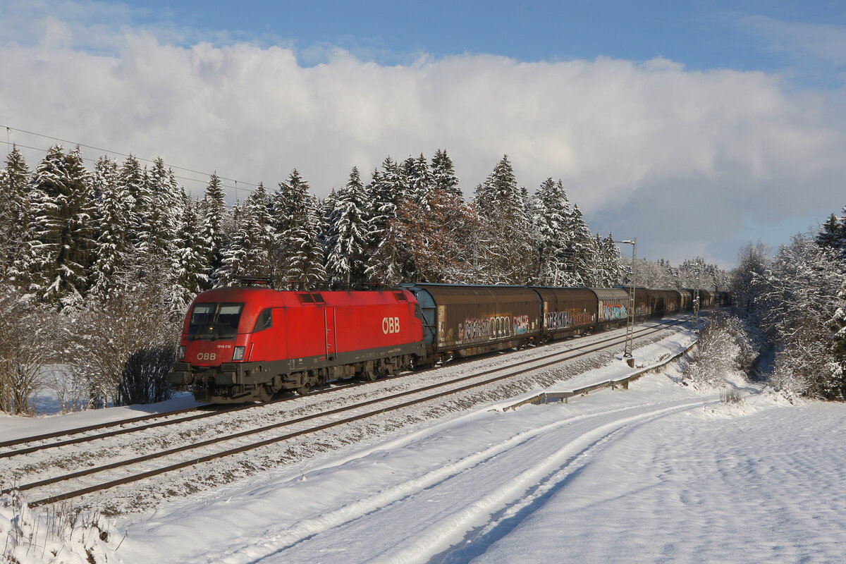 1016 018 war am 12. Dezember 2022 mit einem Schiebewandwagenzug bei Grabensttt im Chiemgau in Richtung Mnchen unterwegs.