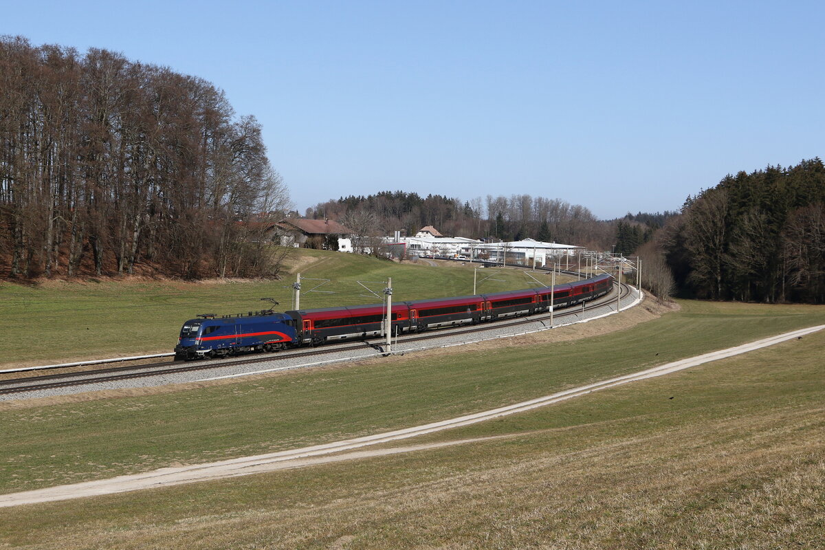 1116 195 mit einem  Railjet  aus Salzburg kommend am 7. Mrz 2025 bei Axdorf im Chiemgau.
