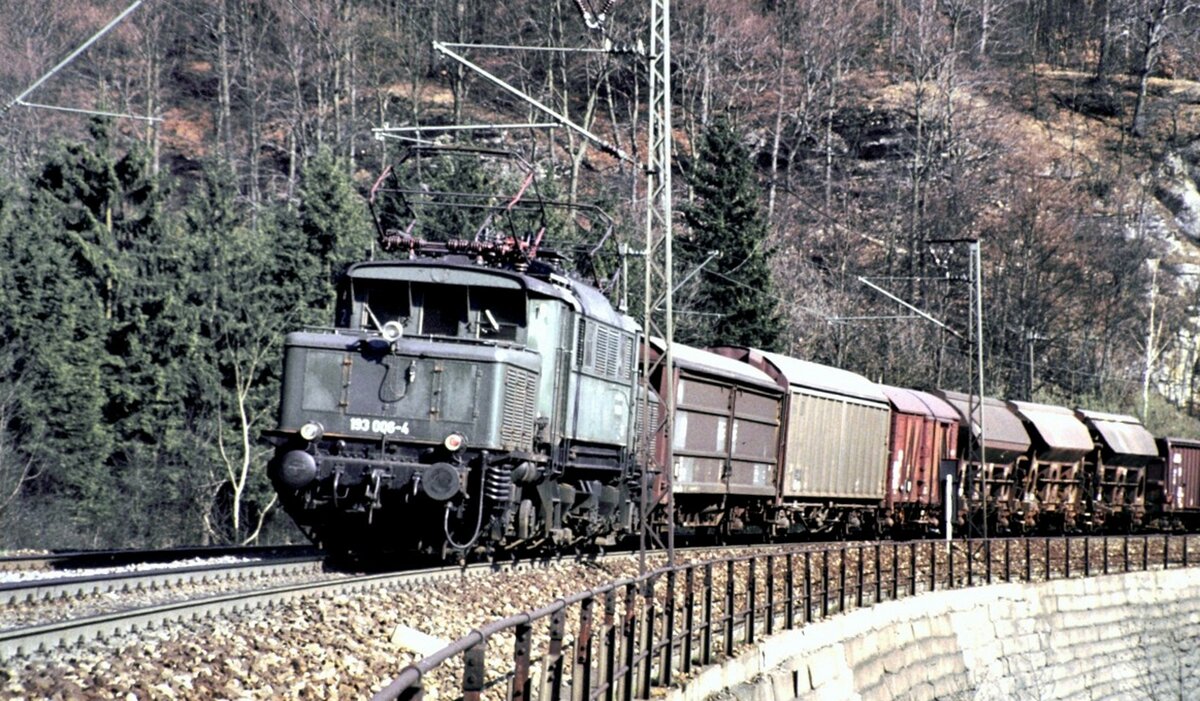 193 006-4 gibt Schubhilfe fr einen gemischten Gerzug auf dem Mhltalfelsendamm der Geislinger Steige am 23.04.1982.
