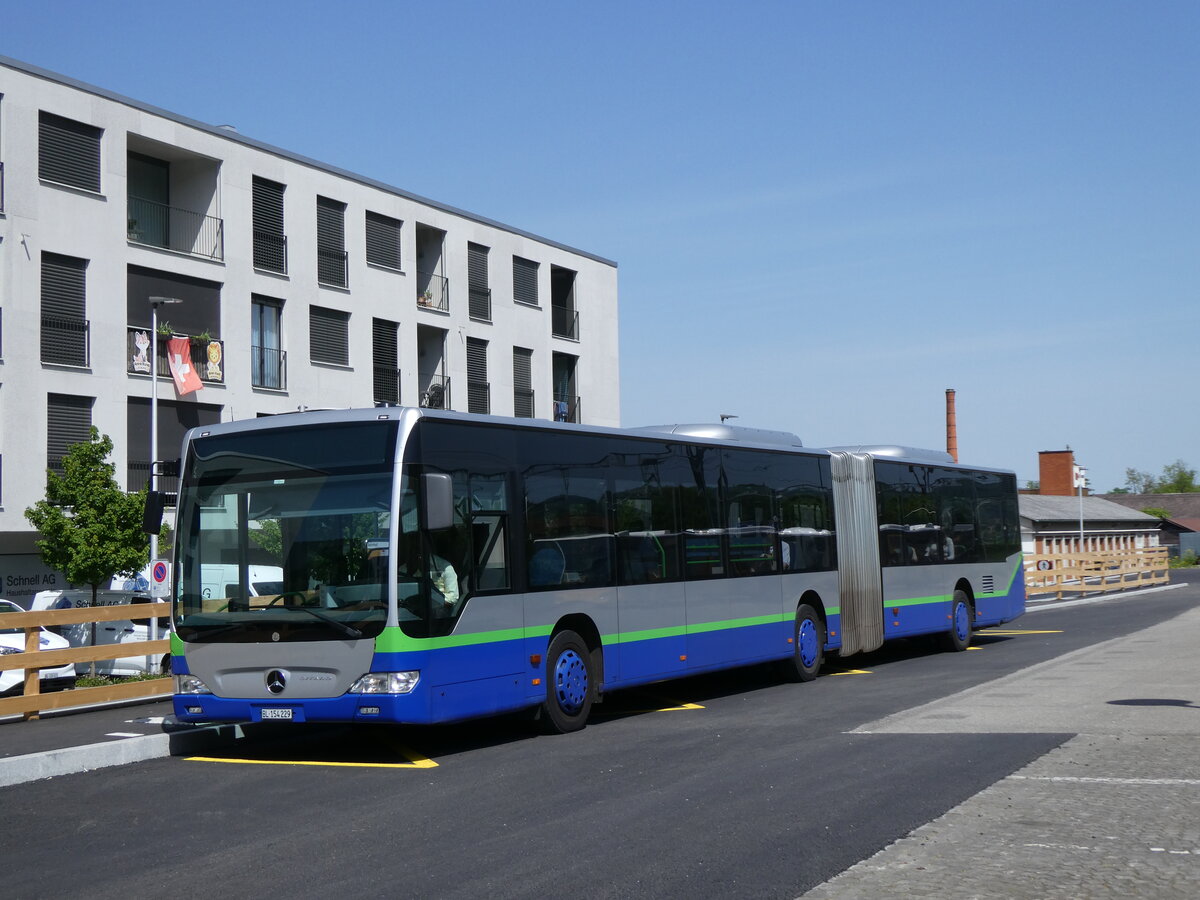 (274'447) - PostAuto Nordschweiz - BL 154'229/PID 12'420 - Mercedes (ex TPL Lugano Nr. 404) am 2. Mai 2025 beim Bahnhof Aesch