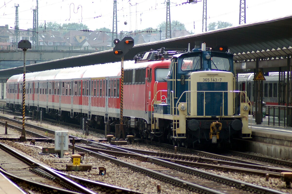365 143-7 schleppt 110 450-4 mit Nahverkehrszug aus dem Ulmer Bahnhof am 28.08.2007.