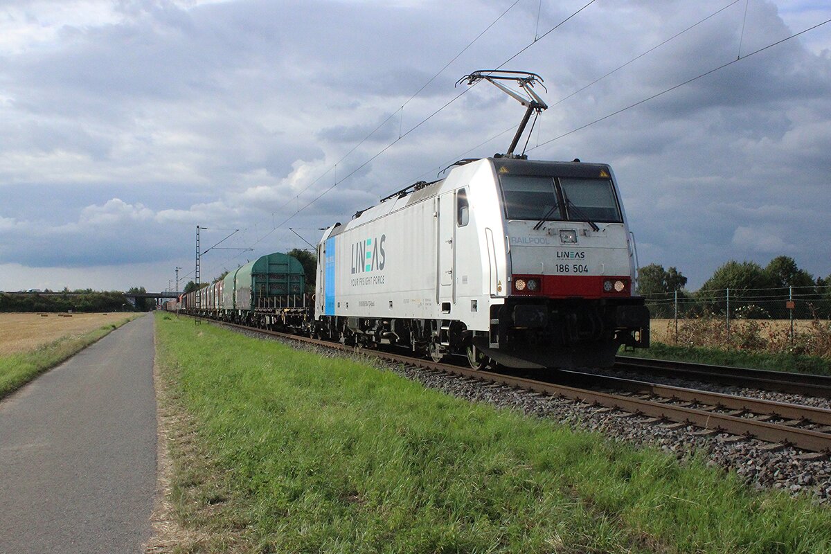 Am 23 Juli 2025 zieht Lineas 186 504 ein Stahlzug durch Karst-Broicherheide.