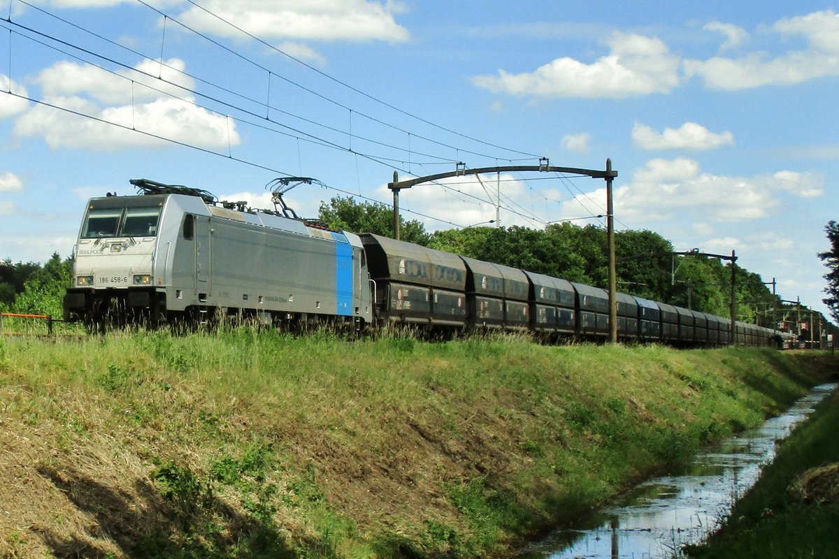 Am übersonnigen 10 Juni 2017 passiert ein Kohlezug mit 186 458 Tilburg Oude Warande.