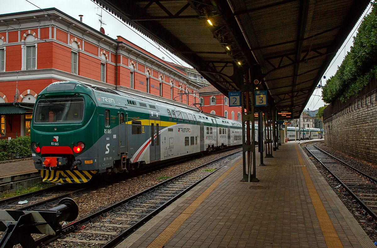 
Der fünfteilige Treno Servizio Regionale (TSR) R5 065 bzw. EB 711 -132 (auch geführt als ALe 711) steht am 03.11.2019 im FN (Ferrovie Nord Milano) Bahnhof Como Lago (oft auch Como Nord Lago bezeichnet) zur Abfahrt bereit. 

Der Treno Servizio Regionale (TSR) bzw. FS ALe 711 / ALe 710  ist ein italienischer Doppelstock-Triebwagen-Zug. Er wird unter anderem von Trenord und Trenitalia im S-Bahn-Verkehr eingesetzt. Entwickelt wurde das elektrisch angetriebene Fahrzeug von AnsaldoBreda, heute Hitachi Rail Italy. Ein Zug wird aus 3 bis 6 Triebwagen zusammengestellt.

Der Treno Servizio Regionale (TSR) ist eine Weiterentwicklung der Treno Alta Frequentazione (TAF) bzw. ALe 426/Le 736/ALe 506. Das Hauptmerkmal der TSR ist die Modularität, da die TSRs nur aus zwei Fahrzeugtypen bestehen, und zwar den Endwagen mit Führerstand und Stromabnehmer und den Mittelwagen. Im Gegensatz zum TAF, bei dem die Traktion nur von den beiden Endwagen ausgeführt wird, ist beim TSR jedes Wagenteil motorisiert: Dies ermöglicht die maximale Flexibilität bei der Zusammenstellung der Züge, die je nach Dienstanforderung unterschiedlich lang sein kann, ohne Änderungen ihre Leistung. Die verteilte Traktion hat auch die meisten Griffprobleme gelöst, die für einige Linien des Ferrovienord-Netzes typisch sind und sogar Steigungen von 30 Promille erreichen (wie der Abschnitt zwischen Como Borghi und Camerlata).

Die Endwagen haben bei der FN die BR-Bezeichnung EB.711 und die Zwischenwagen EB.710, während sie bei der Nationalen Agentur für Eisenbahnsicherheit als ALe 711 bzw. ALe 710 registriert sind.

TECHNISCHE DATEN (fünfteiliger Triebzug):
Spurweite:  1.435 mm (Normalspur)
Achsformel:  Bo'2' + Bo'2' + Bo'2' + 2'Bo' + 2'Bo'
Zugzusammensetzung: EB.711/ EB.710/ EB.710/ EB.710/EB.711
Länge über Puffer: 130.995 mm (26.460/3 x 26.025/26.460 mm)
Achsabstand im Motor-Drehgestell:  2.650 mm
Achsabstand im Lauf-Drehgestell:  2.550 mm
Breite: 2.828 mm
Höhe:  4.300 mm
Eigengewicht:  275 t ( 58 + 53 + 53 + 53 + 58 t)
Höchstgeschwindigkeit:  140 km/h
Dauerleistung: 5 x 680 kW = 3.400 kW 
Stromsystem:  3 kV Gleichstrom
Sitzplätze:  558  (96 im EB.711 und 122 im EB.710)

