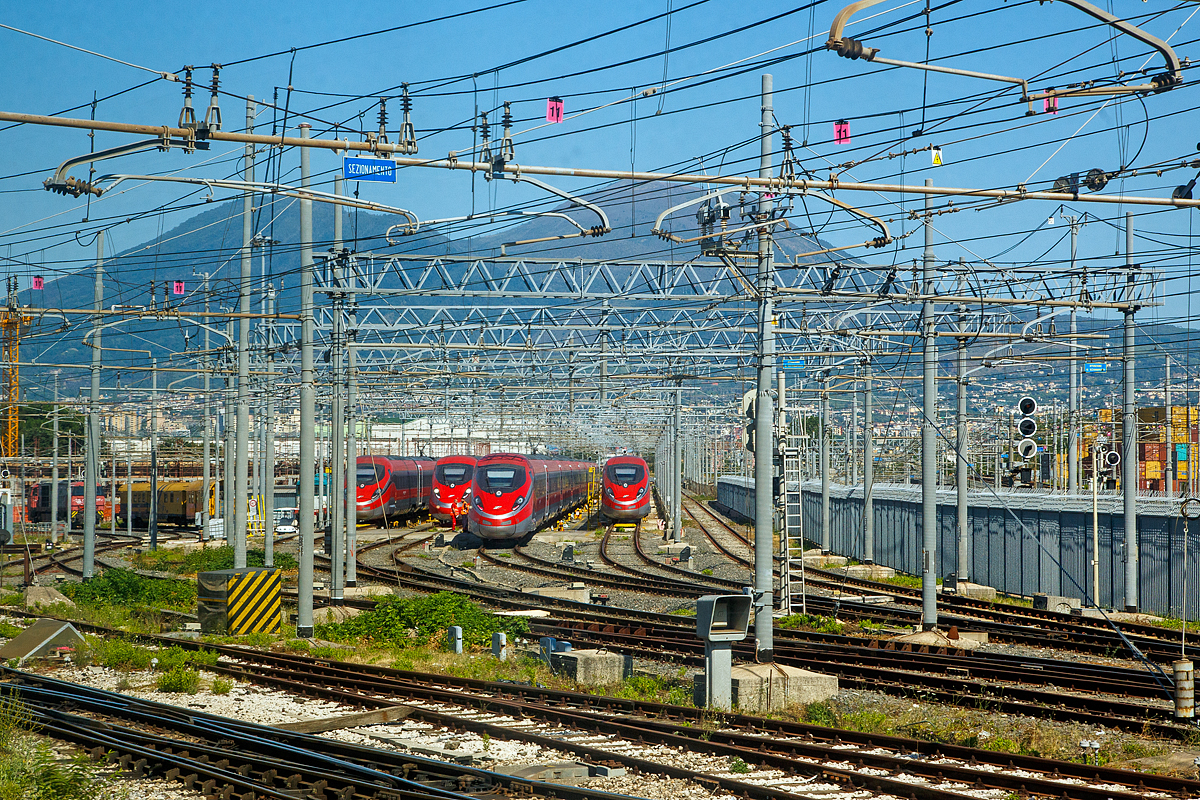 Der Trenitalia am 14.07.2022 aus dem Zug ins Depot / in die Abstellgruppe in Neapel (Napoli) geschaut, hier stehen vier ETR 400 / Frecciarossa 1000 ( Rote Pfeil 1000 ).

Im Hintergrund kann man den Vesuv erkennen.