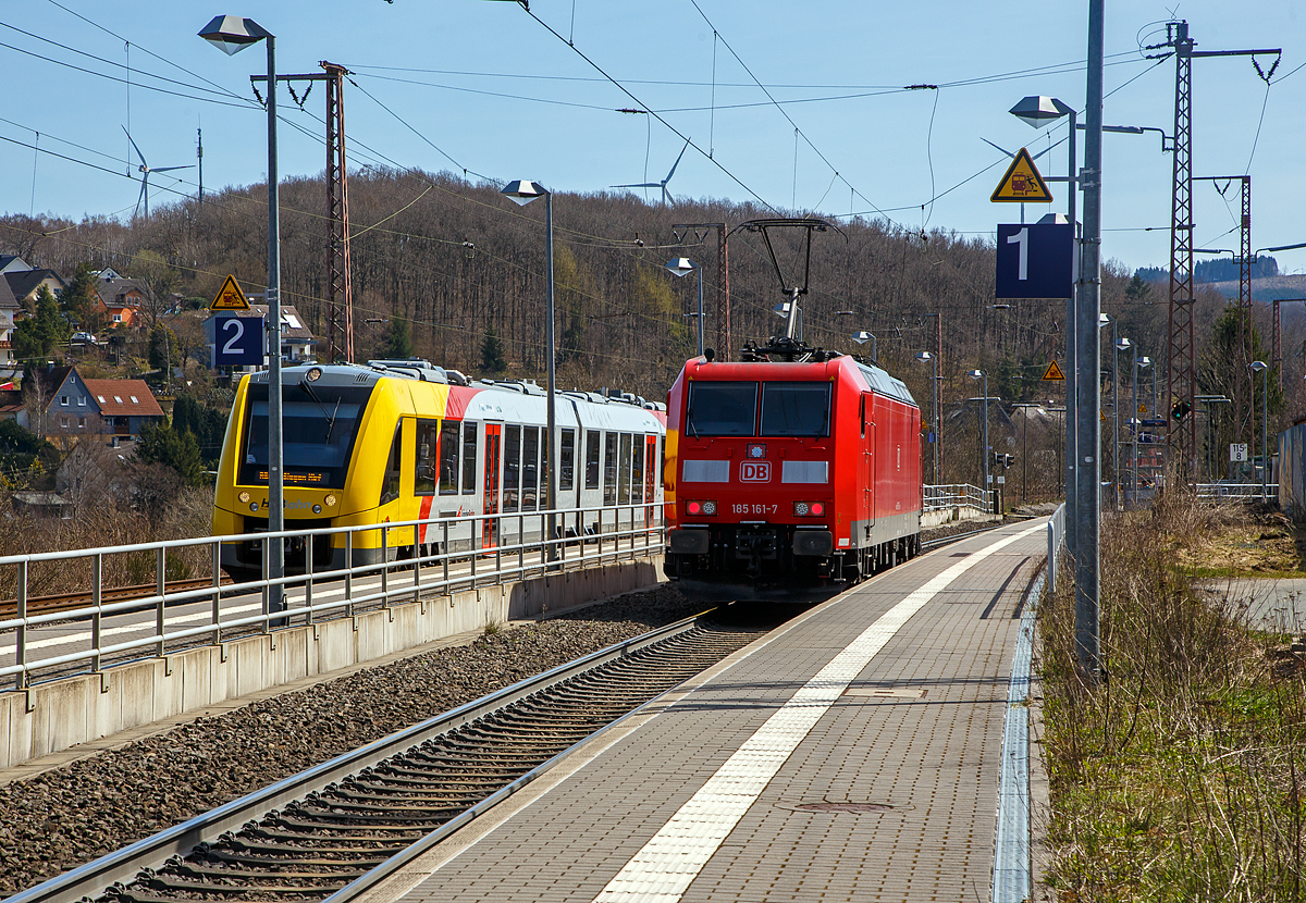 Die 185 161-7 (91 80 6185 161-7 D-DB) der DB Cargo rauscht (Hg ist hier 90 km/h), als Lz (Lokzug) bzw. auf Tfzf (Triebfahrzeugfahrt), am 11.04.2022 auf Gleis 1 durch den Hp Rudersdorf (Kr. Siegen) in Richtung Dillenburg. Erst kurzzuvor hatten Personen, bei geschlossener Schranke, einfach das Gleis 1 überquert und wollen den auf Gleis 2 eingefahrenen RB 95  Sieg-Dill-Bahn  erreichen, der hier auf Gleis 2 steht. Der Triebfahrzeugführer von den zwei gekuppelten Dieseltriebzügen vom Typ Alstom Coradia LINT 41 (HLB VT 505 und VT 504) ausgestiegen und weist diese unvernünftigen Menschen zurecht bzw. Erklärt was hätte passieren können.