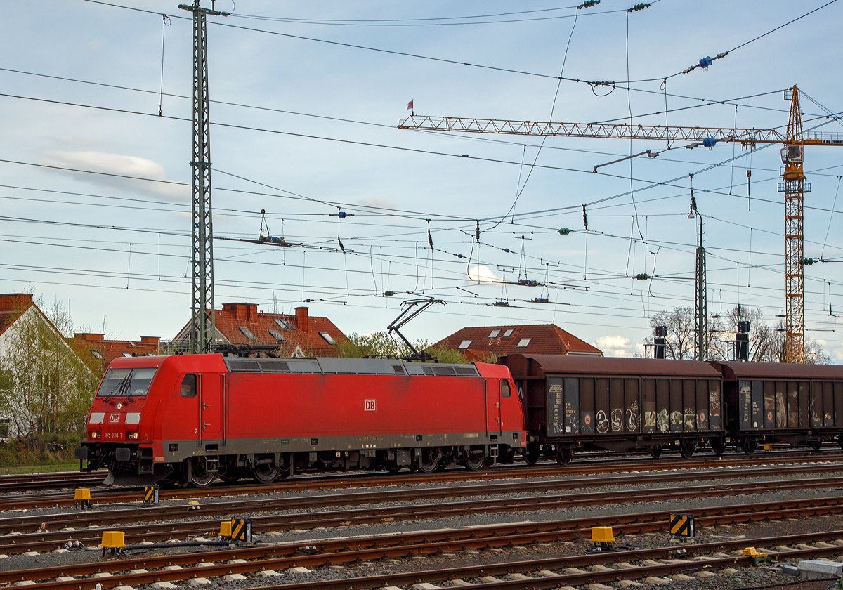 Die 185 338-1 (91 80 6185 338-1 D-DB) der DB Cargo fährt am 14.04.2018 mit einem Gedeckten Güterzug (Wagen der Gattung Hbillns) durch Friedberg (Hessen) in Richtung Norden.