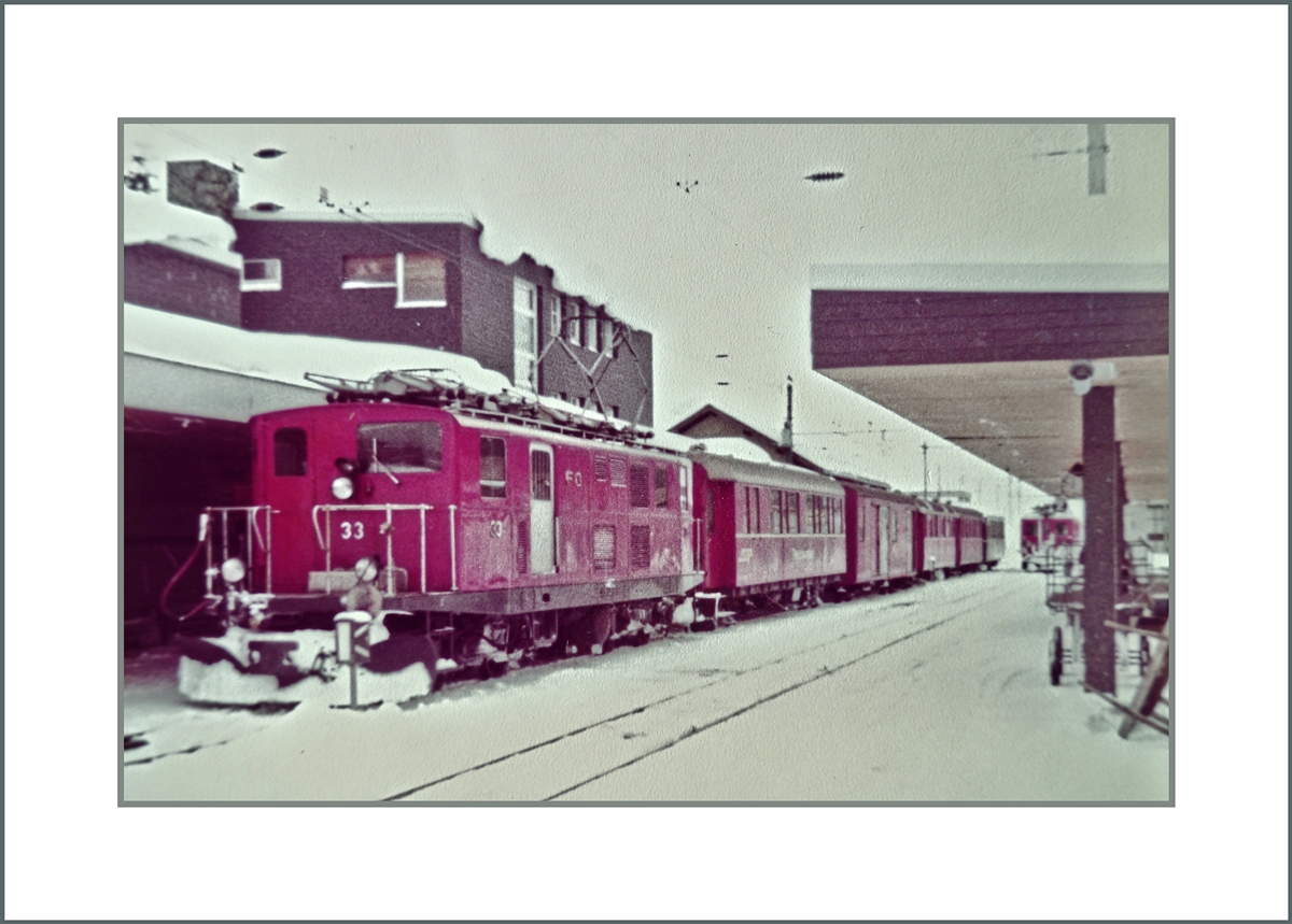 Die FO HGe 4/4 I N° 33 wartet in Andermatt auf  die Abfahrt nach Disentis.
Fotografiertes 110-Film Bild; 13. März 1982