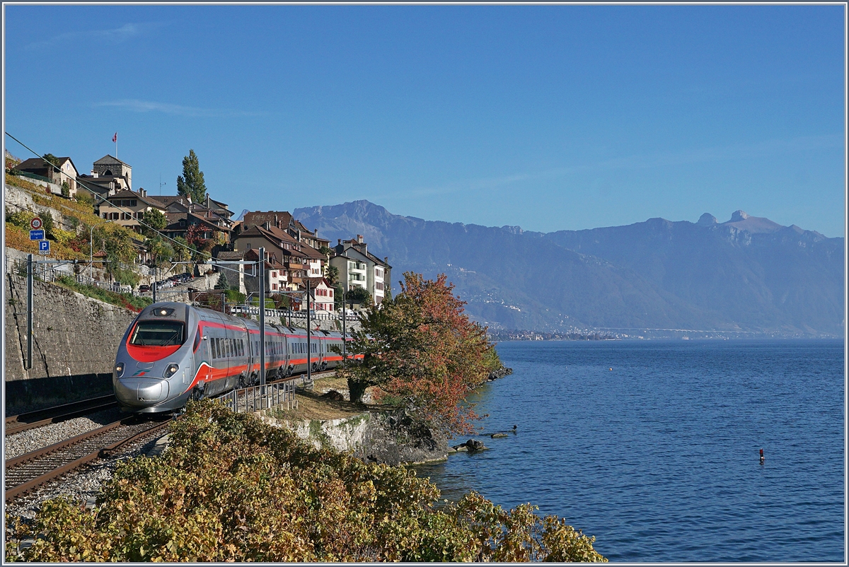 Ein FS Trenitalia ETR 610, als EC 34 von Milano nach Genève unterwegs zeigt sich bei St-Saphorin vor dem Hintergrund des malerischen Ortes Waadtländer Alpen. 25. Okt. 2018