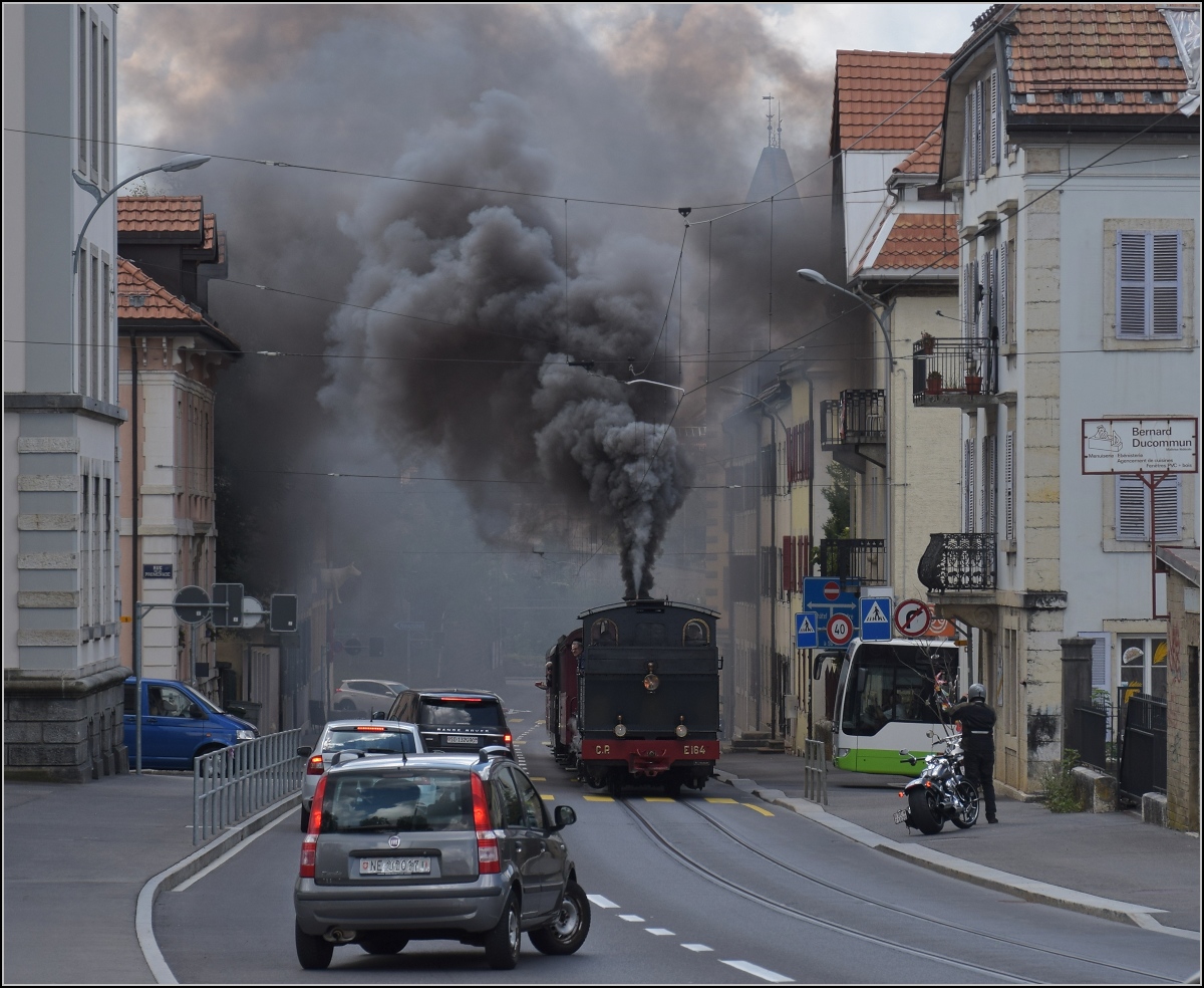 Eine etwas ungewöhnliche Verkehrsteilnehmerin in La Chaux-de-Fonds. 

Rette sich, wer kann. Denn CP E 164, heute bei La Traction, schnaubt mit viel Rauch als Geisterfahrerin die Rue du Manège hinauf. So sammeln sich respektvoll immer mehr Autofahrer auf der falschen Strassenseite oder biegen noch schnell in die Seitenstrasse ab ohne sich rechts einzusortieren. September 2021.