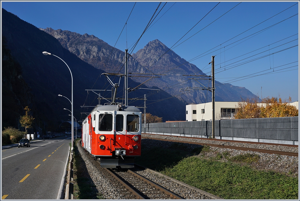 Für einige Zeit wurde die Strecke von Martiny nach Châtelard (TMC / MC) infolge Bauarbeiten mit Busen bedient. Da die Strassenführung erheblich von der Streckenführung der Bahn abweicht, wurde zwischen Martigny und Vernayaz MC ein stündlicher Pendelbetrieb eingerichtet, welcher nach meinem Augenschien mit einem BDeh 4/4 abgewickelt wurde. Am letzten Tag der Bauarbeiten machte ich mich endlich auf, um die sonst im Regelverkehr eher selten anzutreffenden Triebwagen zu fotografieren. Dies erwies sich als weit schwieriger als gedacht, da die Strecke auf der Süd- und Sonnen- Seite durchgehend von der Strasse mit Leitplanken begleitet wird und zudem die  Sonnenseite  in Anbetracht der hohen Berge auf dem überwiegenden Teil der Strecke im Schatten liegt. Also begnügte ich mich Aufnahmen in Vernayaz MC und bei der ehemaligen Haltestelle La Bâtiaz (EH). Im Bild ist der TMR / MC BDeh 4/4 N° 8 auf der Fahrt nach Martigny, kurz vor der ehemaligen Haltestelle La Bâtiaz zu sehen. Links im Bild erkennt man die erwähnte  schattigen Sonnenseite  mit der Strasse nach Vernayaz. 
18. Nov. 2018