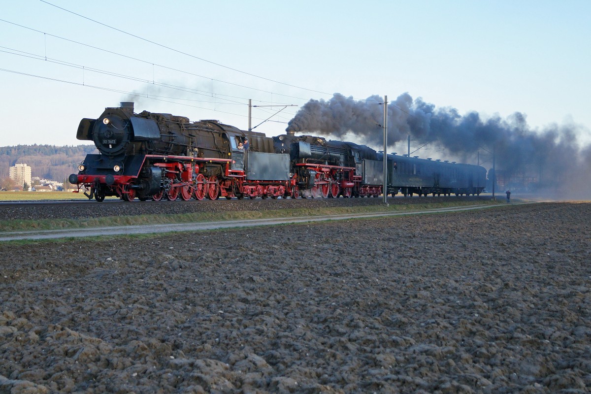 Grosser Bahnhof Wohlen: Die Ankunft des Dampfzuges mit drei Dampflokomotiven vermochte eine sehr grosse interessierte Zuschauermenge zu mobilisieren. Am Abend des 7.3.2015 setzten die 50 3673 und die 01 202 mit dem Rest des Zuges alleine fort in Richtung Olten. Die Aufnahme ist im letzten Abendlicht bei Hendschiken entstanden.
Foto: Walter Ruetsch 