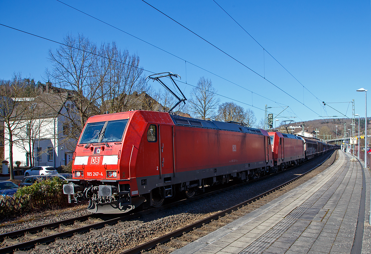 In Doppeltraktion fahren die 185 247-4 und die 185 282-1 der DB Cargo AG am 18.03.2022, mit einem langen gedeckten Güterzug (großräumige Schiebewandwagen der Gattung Habiiins o.ä.), durch den Bahnhof Kirchen (Sieg) in Richtung Köln.