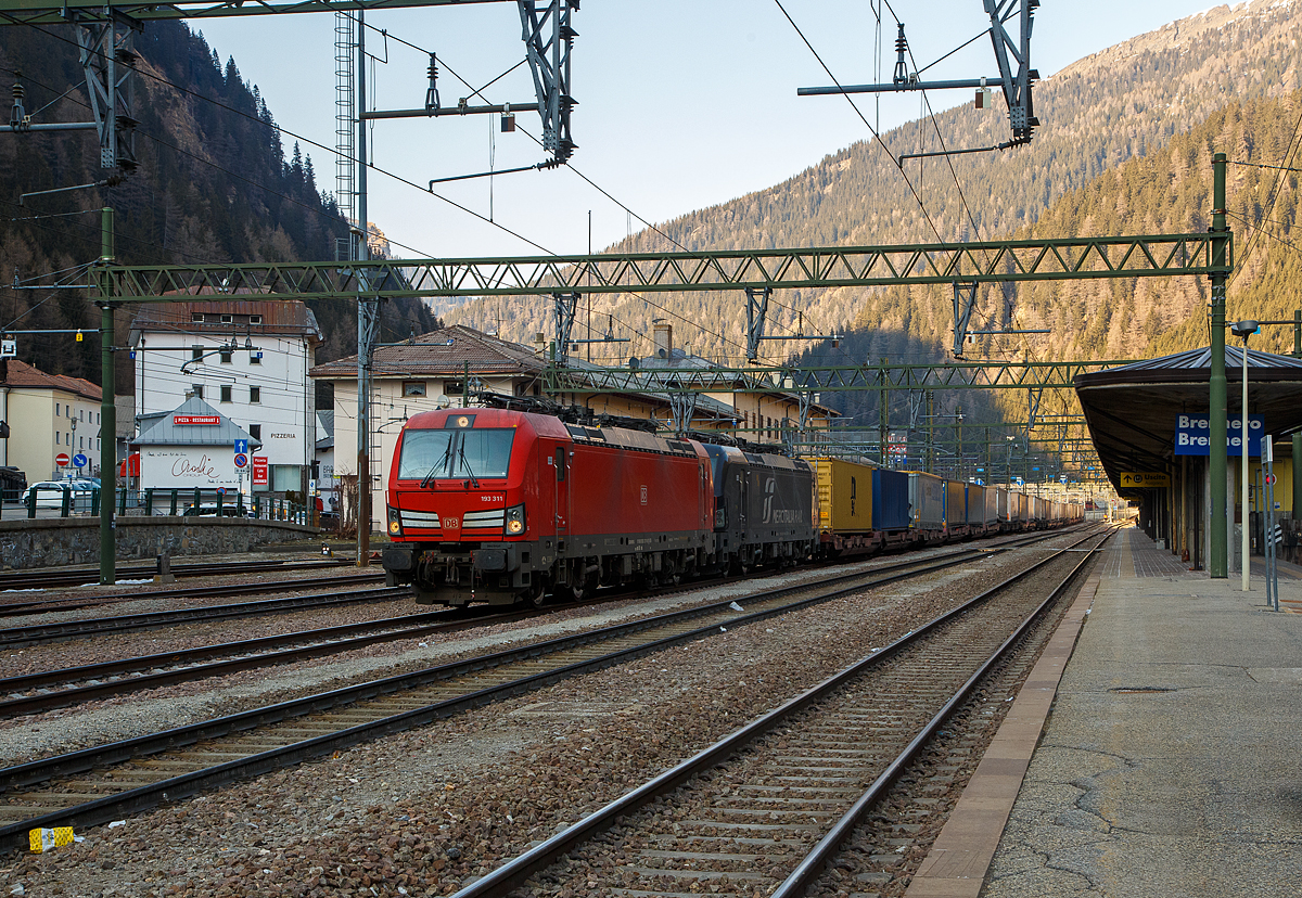 In Doppeltraktion, wobei gerade mit gesenkten Stromabnehmern ausrollend, haben zwei Siemens Vectron MS mit einem KLV-Zug, aus sterreich kommend, den Bahnhof Brenner (Stazione di Brennero) erreicht. Vorne die 193 311 (91 80 6193 311-8 D-DB) der DB Cargo und dahinter die an die Mercitalia Rail S.r.l. vermietete X4 E – 704 / 193 704 (91 80 6193 704-4 D-DISPO) der MRCE Dispolok GmbH (Mnchen). Nach den Formalitten und dem Wechsel vom Lokfhrer, werden spter die Stromabnehmer (fr 3 kV DC), nun unter dem italienischen 3 kV Gleichstrom, angehoben und die weitere Fahrt in Italien kann fortgesetzt werden.

Beide Siemens Vectron MS wurde 2018 von Siemens in Mnchen-Allach gebaut, die DB 193 311 unter der Fabriknummer 22452 und die MRCE 193 704 unter der Fabriknummer 22388. Diese Vectron Lokomotiven sind als MS – Lokomotive (Multisystem-Variante) mit 6.400 kW konzipiert und zugelassen fr Deutschland, sterreich, Schweiz, Italien und Niederlande (D/A/CH/I/NL), Die DB Vectron ist fr eine Hchstgeschwindigkeit von 200 km/h und die MRCE Vectron ist fr eine Hchstgeschwindigkeit von160 km/h zugelassen.