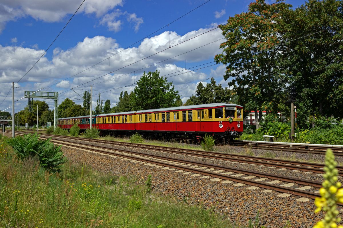 Lange Zeit war in Berlin kein historischer S-Bahn-Zug auf dem ffentlichen Netz zugelassen. Seit 2023 sind zwei Viertelzge unterschiedlicher Bauarten wieder mit gltigen Fristen unterwegs. Im Rahmen der Feierlichkeiten zum 100-jhrigen Jubilum der S-Bahn waren der Stadtbahner 475 605 und ET 3839 Bln der Baureihe ET 167 auf mehreren Sonderfahrten unterwegs, so wie hier bei Johannisthal auf dem Weg in Richtung Flughafen BER.