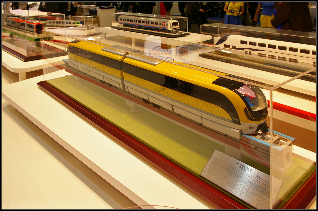 Model of Incheon International Airport MAGLEV.

Am Messestand von Hyundai Rotem war das Modell der Magnetbahn für die Incheon Int'l Airport Corporation in Korea auf der InnoTrans 2014 in Berlin ausgestellt.

Daten: Geschwindigkeit 110 km/h, Spurbreite 1850 mm, Power 1500 V DC, Gewicht 38.2 t, Kapazität 230 Fahrgäste.

Webseite Hersteller (english): https://www.hyundai-rotem.co.kr/Eng/Business/Rail/Business_Record_View.asp?brid=67
