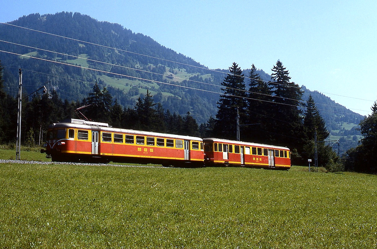 Zwei ehemalige Dieseltriebwagen sind im August 1982 auf der Montafonerbahn unterwegs: Bei dem führenden ET 10.103 oder 104 handelt es sich um den 1935 bei Lindner in Ammendorf für die Deutsche Reichsbahn gebauten ex-VT 63 905 oder 907, den die Montafonerbahn 1961 erwarb und zu einem Elektrotriebwagen umbaute. Dahinter der ES 10.203 oder 204. Diese Fahrzeuge wurde von der Schindler Waggon AG für Mittelthurgaubahn gebaut und dort als ABDm 2/4 Nr. 8 (1951) bzw. Nr. 7 (1954, zweite Besetzung) in Dienst gestellt. Nach der Elektrifizierung der MThB 1965 wurden sie an die Montafonerbahn verkauft und dort zu Steuerwagen umgebaut.