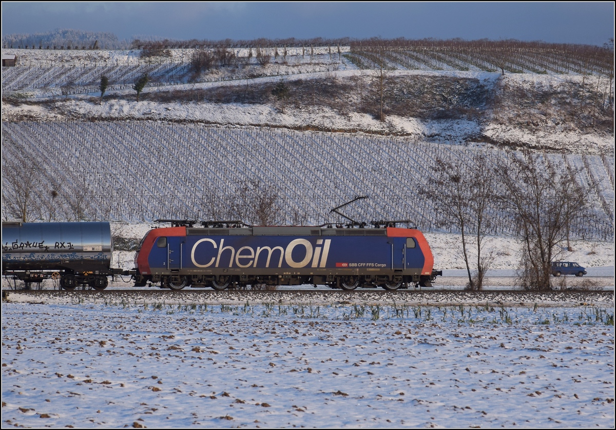 Zwischen Belchensystem und Blauendreieck. 

SBB Cargo Re 482 015 mit ChemOil-Werbung Richtung Basel bei Buggingen. Februar 2021.