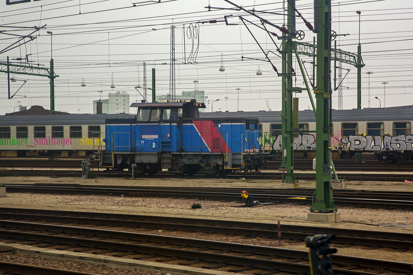 Bei Malmö steht am 20 März 2019 die schwedische Diesellokomotive der Baureihe V5, die  GC V5 152 - 92 74 0000 152-9 S-GC, ex SJ V5 152, eine Henschel DHG 625 C. Ein Bild aus dem EC von Kopenhagen nach Stockholm.

Die Henschel DHG 625 C wurde 1976 von Henschel & Sohn in Kassel (Deutschland) unter der Fabriknummer 31955 gebaut und die SJ (Statens Järnvägar, ehemaligen schwedische Staatsbahnen) geliefert. Nach der 2001 erfolgten Aufteilung von SJ gingen alle Lokomotiven an die Güterverkehrssparte Green Cargo. Sie werden dort unter der Baureihenbezeichnung GC V5 mit den gleichen Betriebsnummern geführt. Im Jahr 2020 ging Nordic Re-Finance AB und wurde an die VÄTE (VÄxling Terminal) in Trelleborg für den Einsatz im Hafen Trelleborg vermietet.

Henschel - DHG 625 C (SJ V 4 bzw. V 5)
Unter der Bezeichnung DHG 625 C wurden zwei recht verschiedene Lokomotivtypen für die schwedische Staatsbahn SJ gebaut. Zunächst wurden im Jahr 1973 zehn Lokomotiven geliefert, die als Baureihe V 4 eingereiht wurden. Sie lehnten sich eng an schwedische Konstruktionen an und ähnelten sehr stark den zu jener Zeit in Schweden entstandenen zweiachsigen Loktypen.

Ab 1975 folgten 40 weitere DHG 625 C, die sich deutlich von den zuvor gelieferten Lokomotiven unterschieden. Sie hatten ein anderes Fahrwerk, das weitgehend dem der gleichzeitig gebauten Standardlokomotiven entsprach. Die Aufbauten waren rechtwinkliger geworden und das Führerhaus sah deutlich mehr nach dem Henschel-Standard aus. Diese Lokomotiven erhielten bei der SJ die Bezeichnung V5. Alle 50 Lokomotiven gingen im Jahr 2001 in das damals aus der SJ ausgegründete Güterverkehrsunternehmen Green Cargo AB über. 

Während die V 4 bereits kurz danach vollständig ausgemustert wurde, stehen die V 5 auch heute noch bei Green Cargo im Einsatz.

TECHNISCHE DATEN:
Anzahl: 40
Hersteller: Henschel & Sohn, Kassel
Baujahre: 1975 bis 1978
Spurweite: 1.435 mm (Normalspur)
Achsfolge:  C
Länge über Puffer: 10.640 mm
Achsstand : 2 x 2.240 = 4.480 mm
Treibraddurchmesser: 985mm (neu)
Motor: (KHD) Deutz wassergekühlter 12-Zylinder –Viertakt-Dieselmotor mit Abgasturboaufladung und Ladeluftkühlung vom Typ BF12M716
Dauerleistung: 380 kW (516 PS)
Kraftübertragung: Dieselhydraulisch
Anfahrzugkraft: 140 kN
Höchstgeschwindigkeit: 40 km/h (Rangiergang) / 70 km/h (Streckengang)
Dienstgewicht: 48,0 t

Die GC V5 152 wurde 2001 mit einem V12-Zylinder-Dieselmotor vom Typ GM 12V-149 mit einer Leistung von 440 kW (600 PS) remotorisiert
