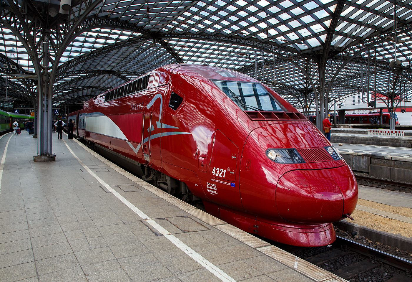 Der PBKA Thalys 4321 - TGV 432710 (93 88 0043 210-7 B-TH etc.) hat, als Thalys 9435 von Paris Gare du Nord (Paris Nord) via Bruxelles-Midi (Brüssel-Süd), Liège-Guillemins (Lüttich) und Aachen Hbf, am 30.04.2023 den Hauptbahnhof Köln.

Die 17 vorhandenen Thalys PBKA sind zusätzlich in der Lage, im deutschen Netz mit 15 kV, 16,7 Hz Wechselstrom und einer Leistung von 4.460 kW zu fahren. Das Design ihrer Triebköpfe lehnt sich an den TGV Duplex an. Sie bedienen seit dem 14. Dezember 1997 Köln. 

Von den 17 Einheiten (mit je 2 Triebköpfen und 8 Mittelwagen) befinden sich sieben im Eigentum der NMBS/SNCB, sechs gehören der SNCF, je zwei der NS und der Deutschen Bahn. Die beiden PBKA-Einheiten Nr. 4321 und 4322 befinden sich im Eigentum der Deutschen Bahn und werden dort intern, wie alle Thalys-PBKA-Triebzüge, als „Baureihe 409“ bezeichnet. Sie sind Bestandteil des Fahrzeugparks der Belgischen Staatsbahn. Der hier gezeigte Triebzug 4332 ist Eigentum der NS - Nederlandse Spoorwegen  (Niederländischen Staatsbahn).

TECHNISCHE DATEN des Thalys PBKA:
Baureihe: 43000 (Belgien und Frankreich) / 409 (Deutschland)
Hersteller: Alstom
Baujahre: 1993 - 1997
Spurweite: 1.435 mm
Achsfolge:  Bo'Bo'+2'(2)(2)(2)(2)(2)(2)(2)2'+Bo'Bo'
Anzahl der Achsen / davon angetrieben: 26 / 8
Triebzuglänge: 200 m
Breite der Mittelwagen: 2.750 mm
Anzahl der Mittelwagen: 8 Mittelwagen
Stromsysteme: 25 kV / 50 Hz AC, 15 kV / 16 2/3 Hz AC, 1,5 kV und 3 kV DC
Technisch zugelassene Höchstgeschwindigkeit:  320 km/h
Höchstgeschwindigkeit im Plandienst: 300 km/h
Antriebsleistung des Zuges: 
8.800 kW (unter 25 kV 50 Hz), 
4.460 kW (unter 15 kV 16 2/3 Hz) und 
3.680 kW (unter 3 kV und 1,5 kV) 
Leergewicht:  416 t
Sitzplätze: 377, davon 120 in der 1. und 257 in der 2. Klasse bzw. im Restaurant