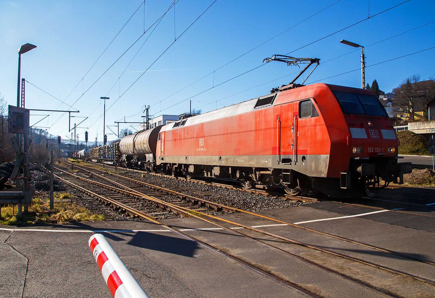 Die 152 130-1 (91 80 6152 130-1 D-DB) der DB Cargo AG fährt am 14.02.2023 mit einem gemischten Güterzug durch Niederschelderhütte, hier beim Bü 343 (km 112,183) kurz vor Niederschelden bzw. der Landesgrenze zu NRW, in Richtung Siegen.

Die Siemens ES64F wurde 2000 noch von Krauss-Maffei in München-Allach unter der Fabriknummer 20257 gebaut.