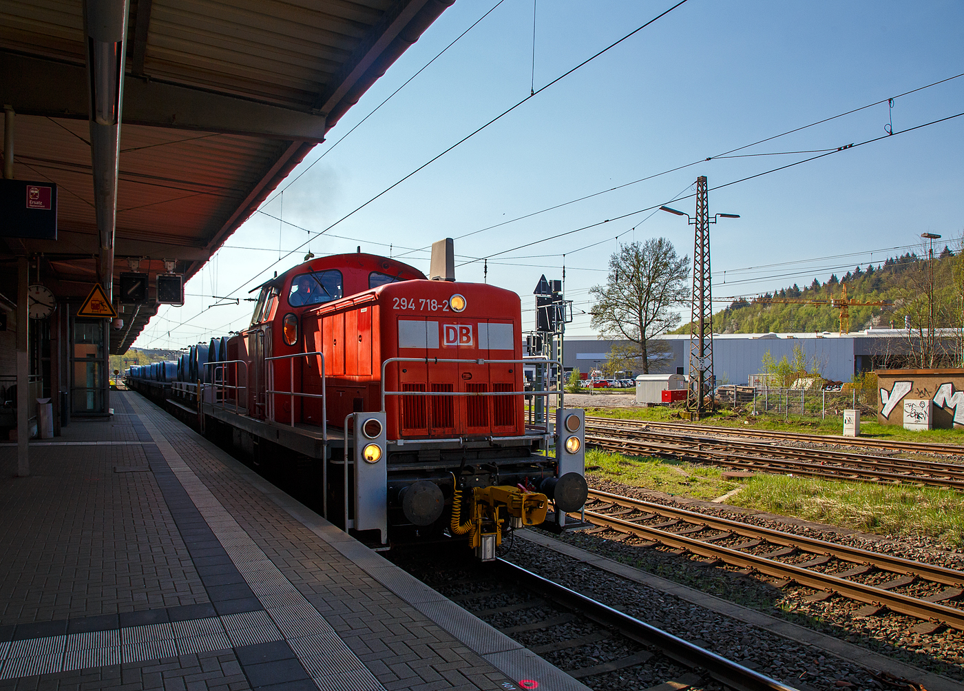 Die 294 718-2 (98 80 3294 718-2 D-DB), eine remotorisierte V 90 der DB Cargo AG fährt am 20.04.2018, mit einem Warmband-Coilzug vom Rbf Kreuztal nach Ferndorf, durch den Bahnhof Kreuztal.

Die Lok wurde 1971 bei MaK in Kiel unter der Fabriknummer 1000526 gebaut und als 290 218-3 an die DB geliefert. Die Ausrüstung mit Funkfernsteuerung (Typ Krauss-Maffei) und Umzeichnung in 294 218-3 erfolgte 1996. Im Jahr 2002 erfolgte durch die DB Fahrzeuginstandhaltung GmbH, in Cottbus eine Remotorisierung durch einen neuen MTU 90° V-8-Zylinder-Dieselmotor mit Common-Rail-Einspritzsystem, Abgas-Turbolader und Ladeluftkühlung, vom Typ 8V 4000 R41. Der Motor ist auf eine Leistung von 1.000 kW (1.341 PS) bei 1.800 U/min gedrosselt. Auch wurden eine neue Lüfteranlage und ein neuer Luftpresser eingebaut, zudem bekam die Lok ein Umlaufgeländer. Durch die Remotorisierung und den Umbau erfolgte auch die Umzeichnung in die heutige 294 718-2.