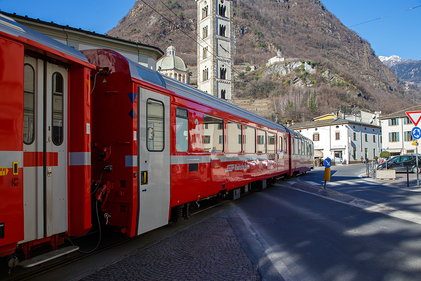 RhB BD 2475 ein vierachsiger verkürzter (Berninabahn) EW IV (PA90) zweite Klasse Personenwagen mit Gepäckabteil, eingereiht in einen RhB Regio von St. Moritz nach Tirano, am 19 Februar 2017 auf der Via Elvezia in Tirano.

Um den schweizerischen Meterspurbahnen die (noch) nicht zu reinen Triebzugeinheiten übergingen kostengünstige Reisezugwagen anbieten zu können, entwickelte SWA - Schindler Waggon Altenrhein (heute Stadler) das  PA90  genannte Baukastensystem, das bei verschiedenen Fahrzeuglängen die Ausführung mit Festfenstern, Senkfenstern oder als Panoramawagen ermöglichen sollte. Dieses Konzept erlaubt eine wirtschaftliche Fertigung von kundenspezifischen Wagenkastenvarianten, wobei auf einheitliche Module zurückgegriffen werden konnte. Während für die 1. Klasse ein einheitlicher Sitzteiler vorgesehen wurde, konnte in der 2. Klasse zwischen den Varianten Regional- und Fernverkehr gewählt werden. Dank besonders großer Sitzteiler und Fensterflächen, sowie den von SIG gebauten, sehr laufruhigen Drehgestellen Typ SIG 90 bieten diese Wagen einen bisher nicht gekannten Komfort.

Einheitliche Merkmale aller Wagen sind:
• Aufbau aus Leichtmetall-Großstrangpressprofilen,
• elektrisch angetriebene außen bündige Schwenkschiebetüren,
• verbesserte Isolation,
• breitere Fenster (1.450 bzw. 1.722 mm),
• geschlossenes WC-System (sofern WC vorhanden).

Die RhB bestellte gemeinsam mit den Appenzeller Bahnen (AB) und der SBB Brünig Bahn insgesamt 31 Wagen in elf verschiedenen Ausführungen, darunter verschiedene Steuerwagen (AB) und sogar Panoramawagen (SBB). Die von der RhB beschafften Fahrzeuge aus diesem Baukastensystem werden als Einheitswagen IV bezeichnet stellen eine konsequente Weiterentwicklung der Einheitswagen II und III dar. Die RhB erhielt ab 1992 siebzehn Personenwagen, davon elf in verkürzter Bauart für den Einsatz auf der Berninabahn. Eins dieser Fahrzeuge wurde als BD mit einem Gepäckabteil ausgestattet, das ist dieser. Die sechs längeren Wagen waren hauptsächlich für den Einsatz auf der Albulabahn.

Die RhB SWA PA90 kurzen Bernina-Wagen sind A 1273  bis 75, B 2491 bis 97 und der BD 2475. Die SWA PA90 langen Albula-Wagen sind A 1281 bis 93 und B 2391 bis 93. Bei den A-Wagen ist die Sitzteilung 2.054 mm und bei den B Wagen 1.782 mm.

Die etwas festere Aluminiumlegierung, die Großprofilbauweise, die vergrößerte Fensterfläche und die verbesserte Isolation zeigten sich aber auch in einem höheren Gewicht. Die Flexibilität des Baukastensystems zeigte sich darin, dass sich die 31 gebauten Wagen auf 11 verschiedene Typen verteilten. Nachbeschaffungen dieses gelungenen Wagentyps gab es jedoch nicht, aber indessen sind viele Elemente in die Konstruktion der Bernina-Express-Panoramawagen eingeflossen.

TECHNISCHE DATEN:
Hersteller: Schindler Waggon AG, Altenrhein
Baujahr: 1992
Spurweite: 1.000 mm
Anzahl der Achsen: 4 (2´2´)
Länge über Puffer: 16.465 mm
Drehgestellbauart: SIG 90
Sitzplätze: 31
Eigengewicht: 16,5 t
Ladegewicht: 2,0 t
zulässige Geschwindigkeit: 90 km/h
Lauffähig: StN (Stammnetz) / BB (Berniabahn) / MGB (Matterhorn Gotthard Bahn)