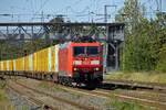 185 134 ist mit einem vollbeladenen DHL-Containerzug in Saarmund unterwegs in Richtung Osten.