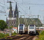   Recht schlecht kann man die Verwandtschaft noch erkennen, rechts fährt gerade ein Siemens Desiro MainLine (BR 460) der Trans Regio in Richtung Hohenzollernbrücke und links erreichten zwei