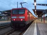 114 038-3 mit RE 33103 von Rostock Hbf Richtung Lutherstadt Wittenberg kurz vor der Ausfahrt um 06.34 Uhr im Rostocker Hbf.(02.09.10)