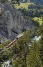 Groß die Schlucht, klein der Zug - Kurz nach der Ausfahrt aus der Station Valendas-Sagogn befindet sich am 24.08.2014 der in Disentis-Mustér gestartete RE 1245 auf der Fahrt nach